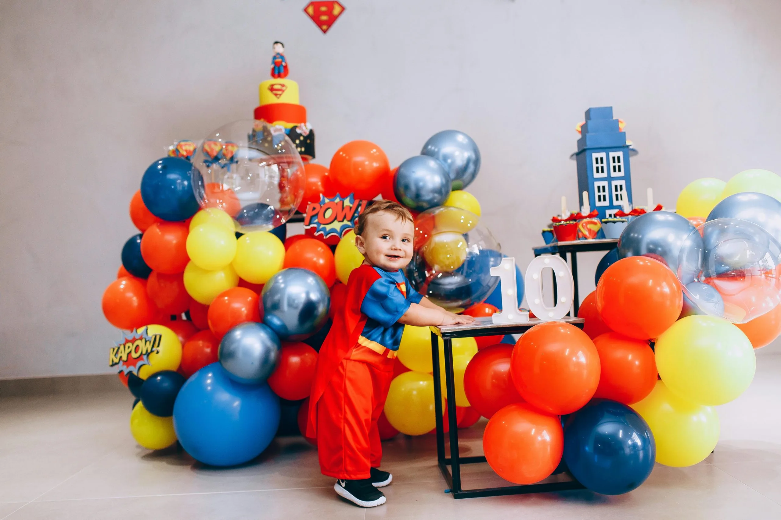 Kids dressed as superheroes enjoying a fun-filled superhero-themed party.